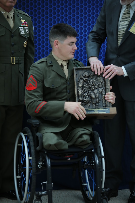 Cpl. Ivan Sears, a staff member of the Family Reception section of the Wounded Warrior-East Bn., San Antonio, Texas Detachment, receives the Wounded Warrior Wounded, Ill or Injured Service Member Award during the Wounded Warrior Awards Reception and Ceremony at the National Museum of the Marine Corps on April 3, 2014. Sears was recognized for his optimism and for his actions as an athlete representing the Wounded Warrior Regiment and the Marine Corps during several sporting events. 