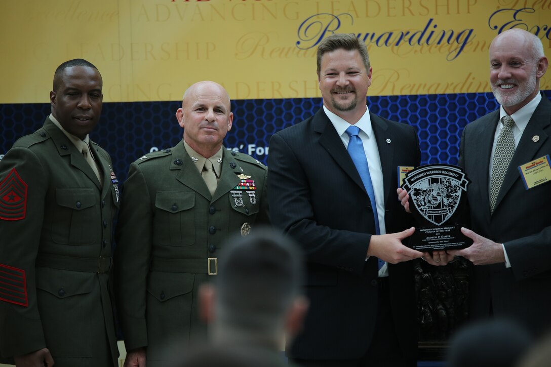 Andrew Gasper, the Careers and Education Specialist for Wounded Warrior Bn. West, Camp Pendleton, Calif., received the Wounded Warrior Regiment Civilian Caregiver of the Year Award during the Wounded Warrior Awards Reception and Ceremony at the National Museum of the Marine Corps on April 3, 2014. Gasper was selected for his role in creating a new processing system that helps pinpoint how to best help the wounded warriors who come through the program. 