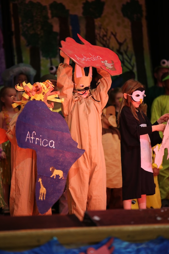 Hannah, a student at John H. Russell Elementary School on Marine Corps Base Quantico, holds up a cut-out of Australia during a musical presentation about the wonders of the earth on April 3, 2014. Hannah and her classmates learned about continents, islands and oceans and the animals that live there.