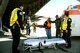 Tech. Sgt. Rosaura Newton informs litter carry volunteers of unloading instructions March 31, 2014, during Ultimate Caduceus 2014, a national disaster exercise at Cheyenne Air National Guard Base, Wyo. During the exercise, AE members provided medical support, processed and transferred patients.  (U.S. Air Force photo/Staff Sgt. Stephenie Wade)