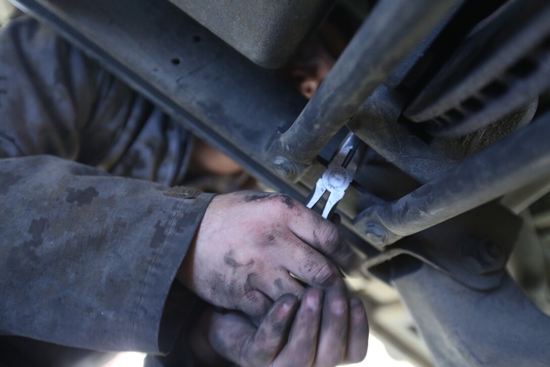 Cpl. Michael McKeon, a native of Falls Church, Va. and a floor mechanic with Combat Service Support Company, I Marine Expeditionary Force Headquarters Group conducts maintenance operations on a High Mobility Multipurpose Wheeled Vehicle aboard Camp Pendleton, Calif., April 2, 2014. By extending work hours for a month, the vehicle readiness percentage went from 75 percent to 95 percent.




