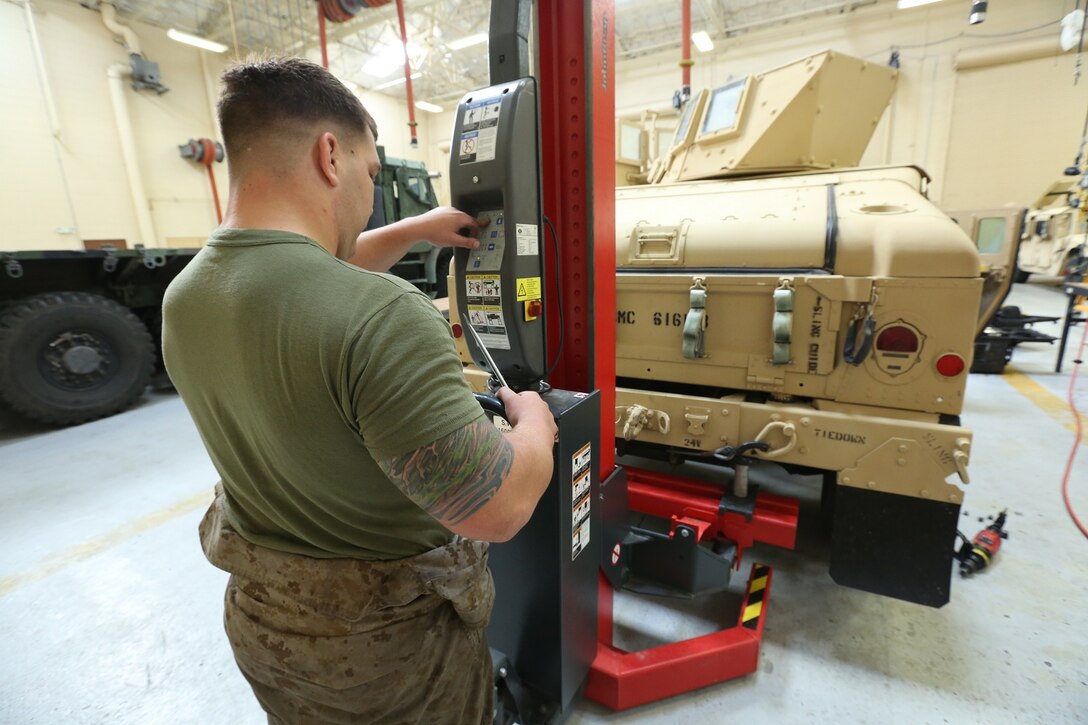 Lance Cpl. Nickolas Barker, a native of Kingsford, Mich., and an automotive maintenance technician with Combat Service Support Company, I Marine Expeditionary Force Headquarters Group, uses a lift to assist with vehicle maintenance operations aboard Camp Pendleton, Calif., April 3, 2014. The Marines rose the operational readiness by 20 percent in a month.




