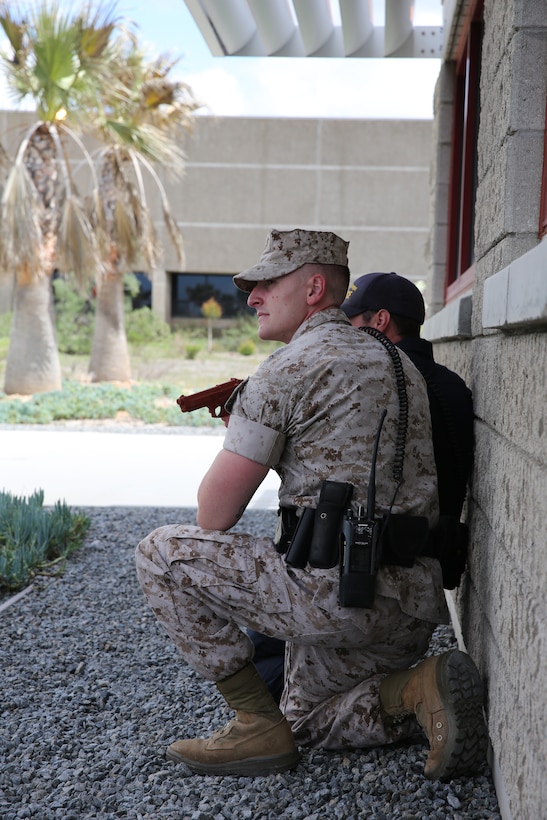 MARINE CORPS AIR STATION MIRAMAR, Calif.—Sgt. Taylor Sanchez and Officer Jason Frederickson, both police officers with the Provost Marshall’s Office, remain tactical while searching for the suspect during an active shooter exercise at the Navy Marine Reserve Center aboard Marine Corps Air Station Miramar, Calif., April 2.  The officers were on scene just six minutes after the call for help was made.