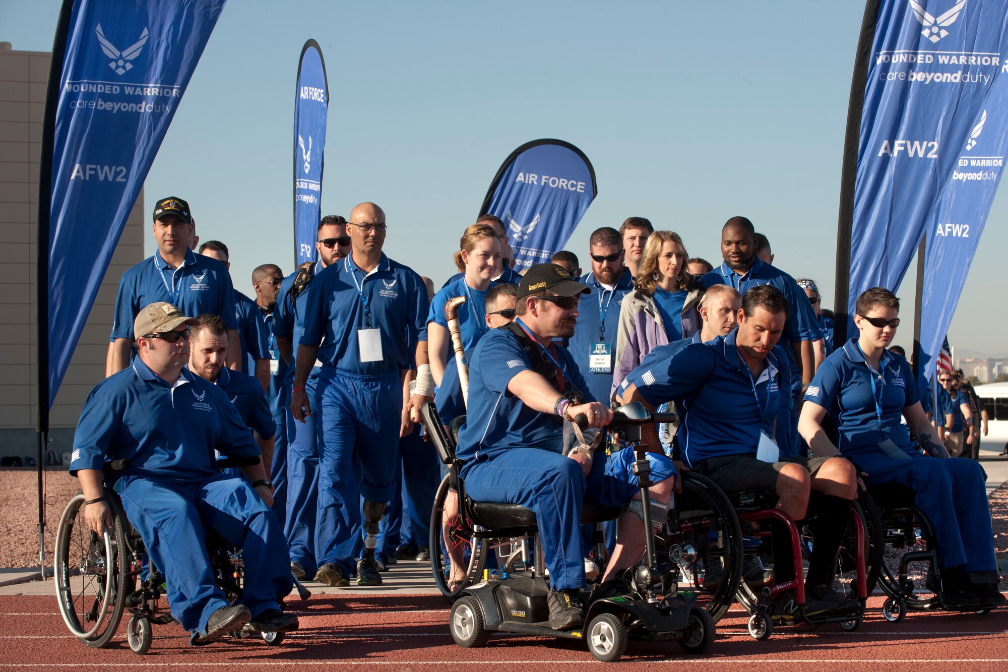Wounded warrior athletes walk onto the field April 7, 2014, at the Warrior Fitness Center track at Nellis Air Force Base, Nev., as part of the Air Force Wounded Warrior Trials.The trials are an adaptive sports camp used to identify which athletes will be selected as members of the Air Force Warrior Games team and compete against other military branches September 2014. (U.S. Air Force photo/Senior Airman Matthew Lancaster)

