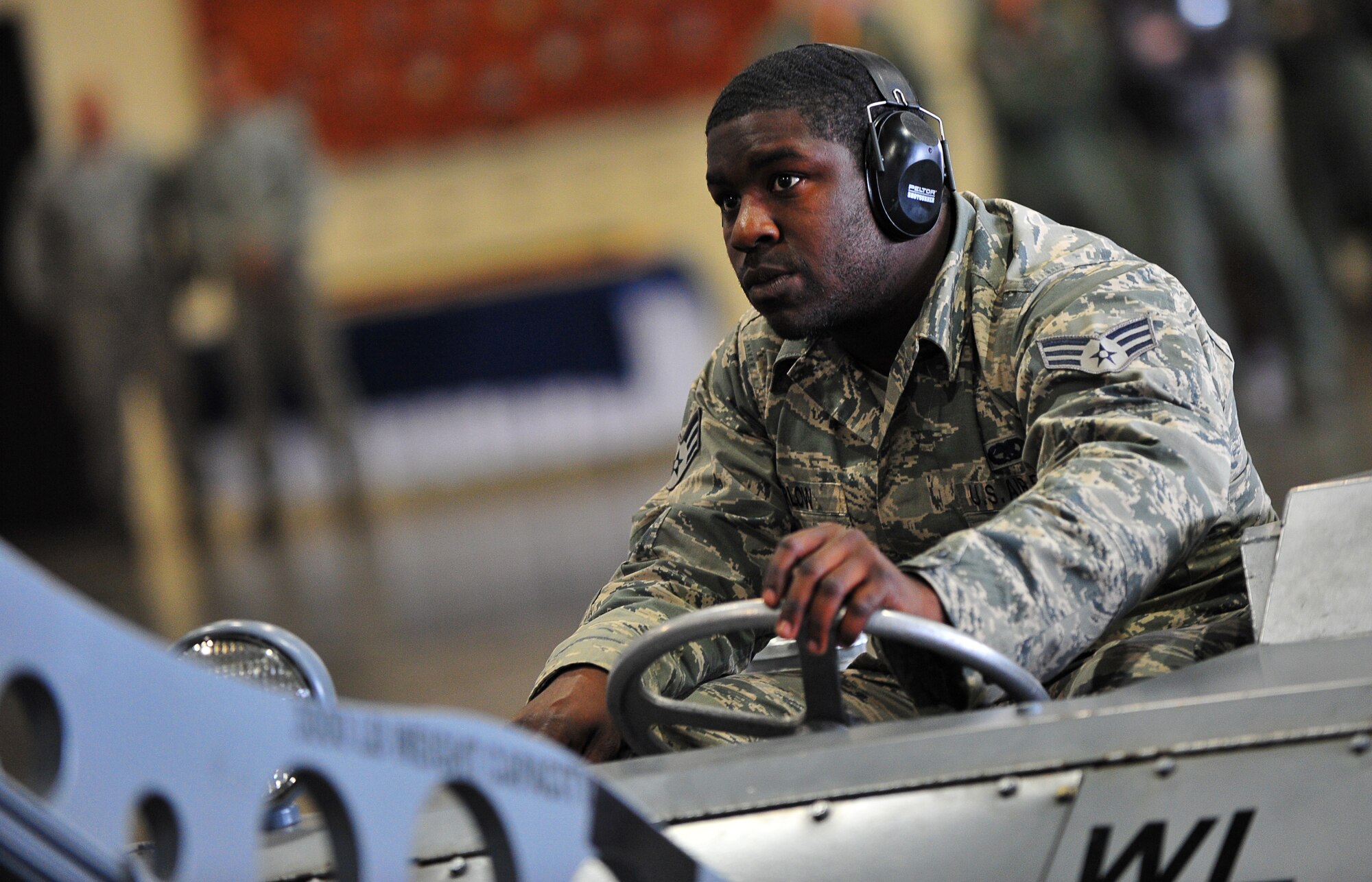 U.S. Air Force Senior Airman Darious Furlow, 14th Aircraft Maintenance Unit weapons load crew member, drives a MJ-1 Lift Truck utilized for moving weapons onto the F-16 Fighting Falcon at Misawa Air Base, Japan, April 4, 2014. Furlow must ensure correct maneuvering procedures to effectively secure weapon placement on the aircraft. (U.S. Air Force photo/Senior Airman Jose L. Hernandez-Domitilo)