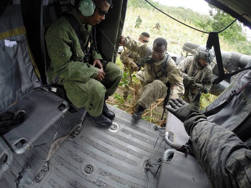 Belizean forces board a U. S. Army UH-60 Blackhawk helicopter to search for marijuana fields in Belize during the marijuana eradication mission.  The operation, which lasted March 15-20, 2014, resulted in the Belizean government destroying 34 marijuana fields and approximately 57,283 mature marijuana plants for an initial estimated value of $29 million.  In addition, the team also found and destroyed 25 pounds of marijuana seeds.  Joint Task Force-Bravo provided aviation support, on-call casualty evacuation and caving ladder training for 52 Belizean personnel who participated in the operation.  (Courtesy photo)