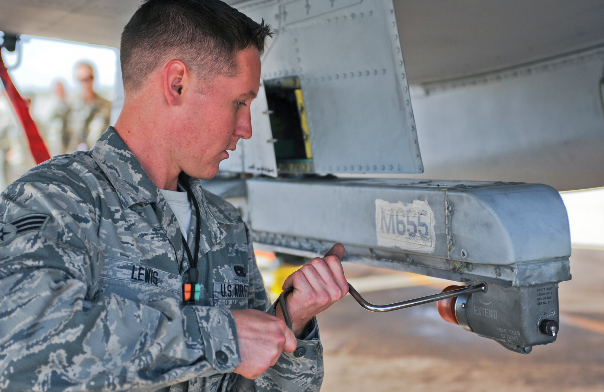 U.S. Air Force Senior Airman Cody Lewis, 924th Aircraft Maintenance Unit three man technician, uses a crank rod during a load crew competition at Davis-Monthan Air Force Base, Ariz., April 4, 2014. Load crews compete with one another to maintain proficiency and promote camaraderie. (U.S. Air Force photo by Senior Airman Sivan Veazie/Released)