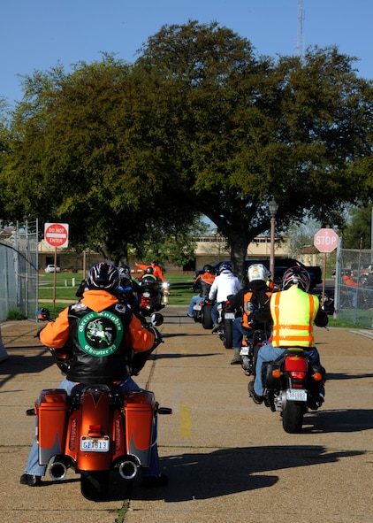 Motorcyclists exit Hoban Hall's parking lot to participate in the Thunder on the Bayou motorcycle ride on Barksdale Air Force Base, La., April 4, 2014. The event was held to build morale and to also promote safety.  More than 70 riders participated in the two-hour ride around the local area.  (U.S. Air Force photo/Senior Airman Joseph A. Pagán Jr.)