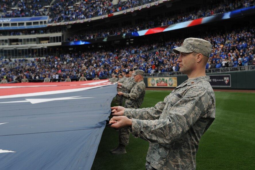 Airmen from Whiteman Air Force Base, Mo., participate in a flag detail at Kauffman Stadium during the Kansas City Royals season opener April 4, 2014. More than 100 Airmen from the base participate in the event. The Royals defeated the Chicago White Sox 7-5.  (U.S. Air Force photo by Airman 1st Class Joel Pfiester/Released)