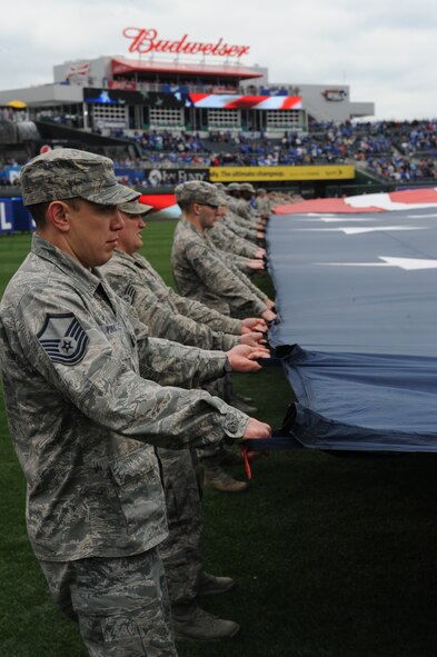 Airmen from Whiteman Air Force Base, Mo., participate in a flag detail at Kauffman Stadium during the Kansas City Royals season opener April 4, 2014. More than 100 Airmen from the base participate in the event. The Royals defeated the Chicago White Sox 7-5.  (U.S. Air Force photo by Airman 1st Class Joel Pfiester/Released)