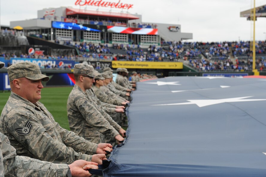 Airmen from Whiteman Air Force Base, Mo., participate in a flag detail at Kauffman Stadium during the Kansas City Royals season opener April 4, 2014. More than 100 Airmen from the base participate in the event. The Royals defeated the Chicago White Sox 7-5.  (U.S. Air Force photo by Airman 1st Class Joel Pfiester/Released)
