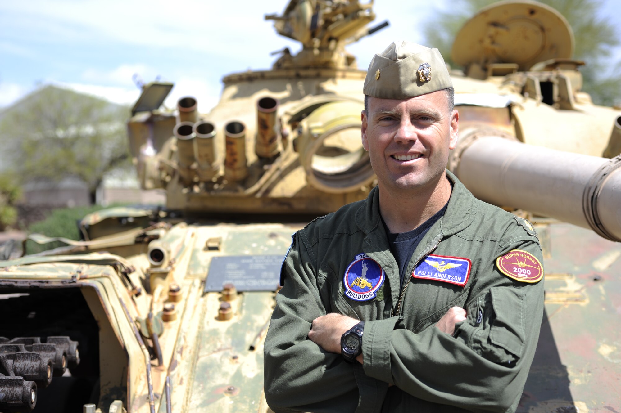 U.S. Navy Lieutenant Commander Eric Anderson, 354th Fighter Squadron assistant director of operations, poses in front of a tank, his unit's landmark at Davis-Monthan Air Force Base, Ariz., April 2, 2014. Anderson arrived at D-M in 2011 as part of an exchange program, giving him the opportunity to work under an Air Force command. (U.S. Air Force photo by Airman 1st Class Betty R. Chevalier/released)