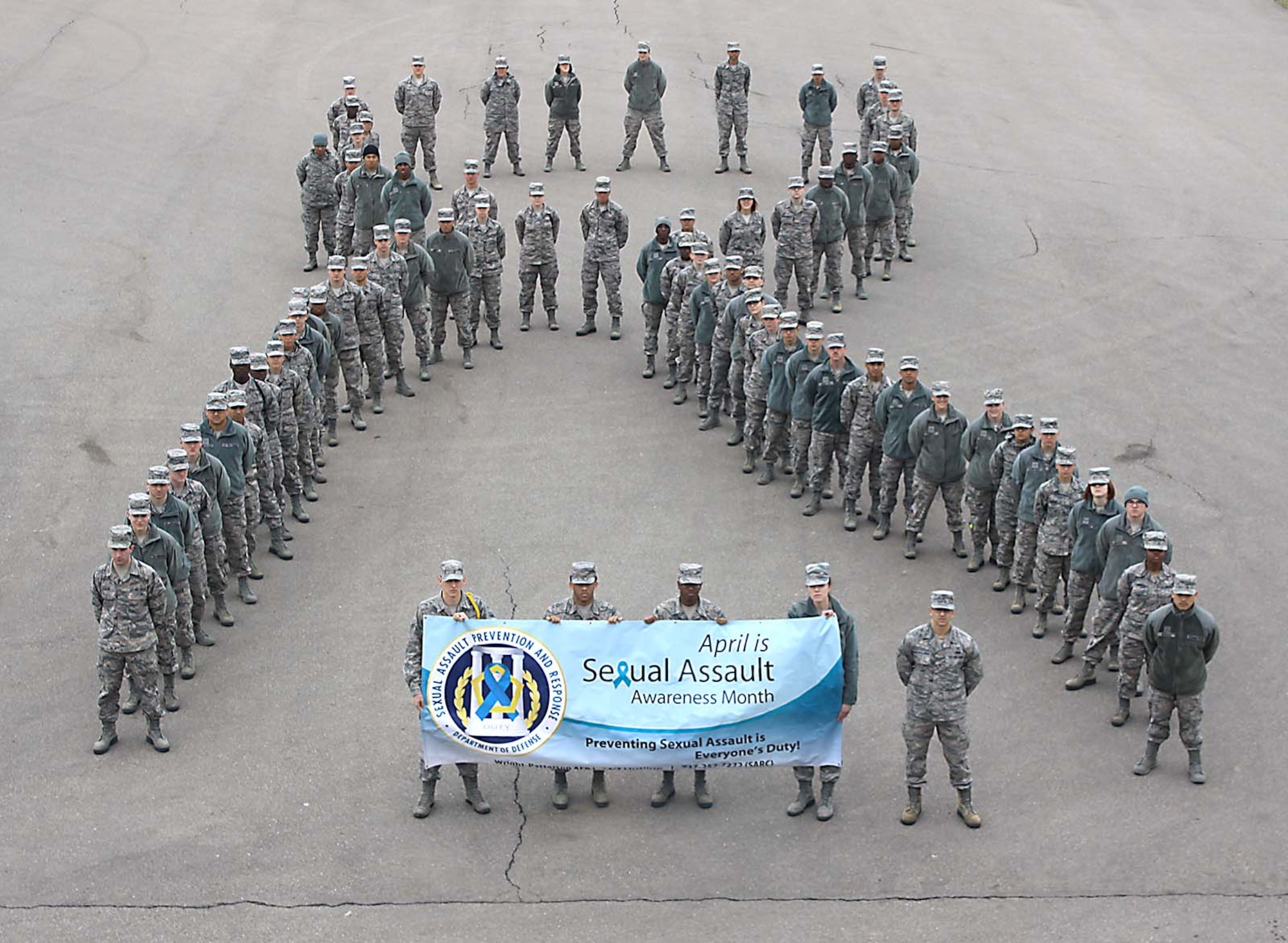 Students from the U.S. Air Force School of Aerospace Medicine form a symbolic human ribbon to show their solidarity for Air Force efforts to end sexual assault.  April is Sexual Assault Awareness Month. (Photo by Tara Dixon Engel)

