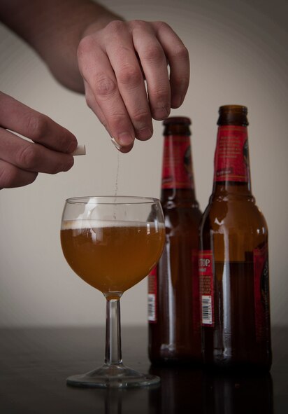 A substance is placed into a drink simulating a real life situation that may occur when a drink is left unattended. At installations around the world Airmen are working together to increase awareness, prevent and care for the victims of sexual assault, with a variety of observances underway in observance of Sexual Assault Awareness Month. (U.S. Air Force photo/Senior Airman Andrew Crawford)