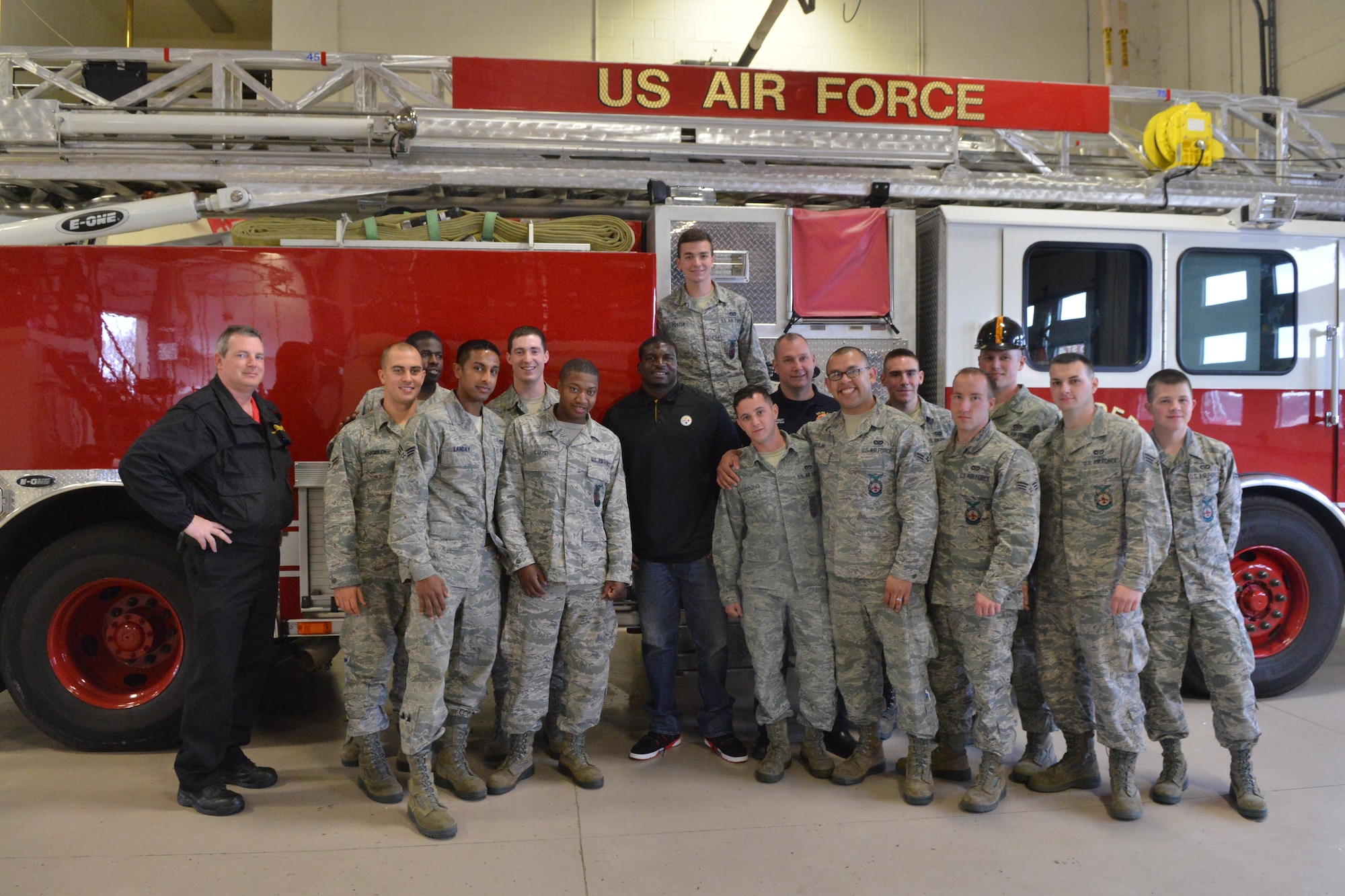 Lawrence Timmons, Pittsburgh Steelers #94 (center), takes a groups photo with the firefighters at Shaw Air Force Base, S.C., March 28, 2014, Timmons conducted an autograph signing and received the commander's coin from U.S. Air Force Col. Clay Hall, 20th Fighter Wing commander. (U.S. Air Force photo by Senior Airman Ashley Gardner/Released)