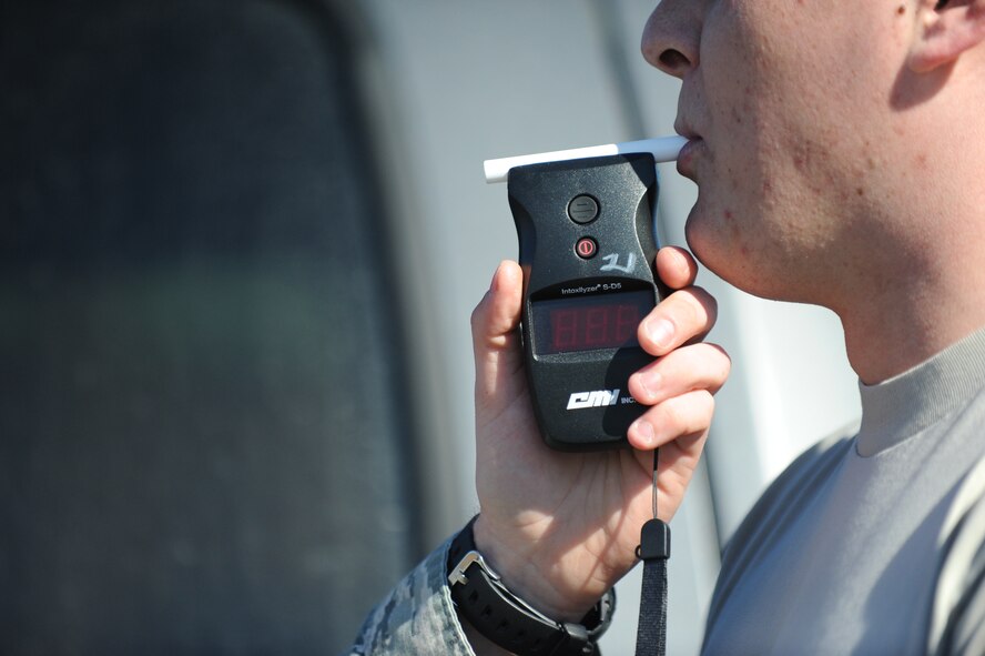 A breathalyzer test is administered on a simulated drunk driver at Minot Air Force Base, N.D., April 7, 2014. Instances of Airmen driving under the influence of alcohol or other substances has been steadily decreasing, with approximately 13 less incidents reported in the first quarter of 2014 than in 2011. (U.S. Air Force photo/Senior Airman Stephanie Sauberan)