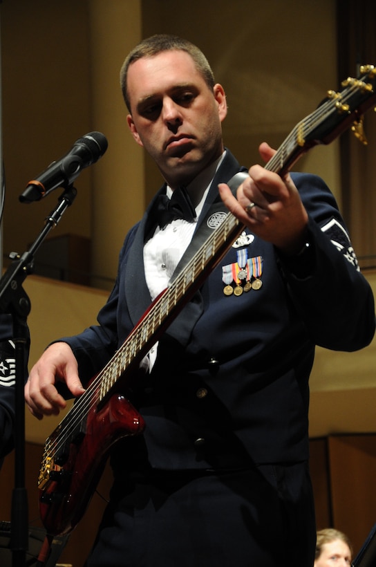 Senior Master Sgt. Eric Sullivan plays the bass guitar as Celtic Aire takes the stage during the U.S. Air Force Band performance at Northwestern University in Evanston, Ill., April 6, 2014. Celtic Aire, an ensemble of the Band, plays classic Irish melodies with new twists. Sullivan, a native of Wilson, N.C., is a vocalist with the Singing Sergeants, the official chorus of the U.S.  Air Force. (U.S. Air Force photo/Master Sgt. Tammie Moore)