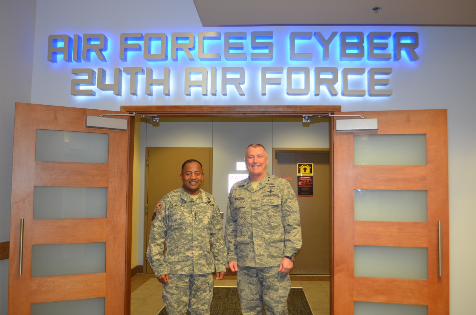 Lt. Gen. Robert S. Ferrell, Army Chief Information Officer, meets with Maj. Gen. J. Kevin McLaughlin, 24th Air Force commander, during the Army Deputy Chief Information Officer Conference March 26 at Kelly Field Annex.  The conference brought together more than 140 participants from across the Army, Air Force, Navy and the Defense Information Systems Agency.  (U.S. Air Force photo/2nd Lt. Meredith Hein)