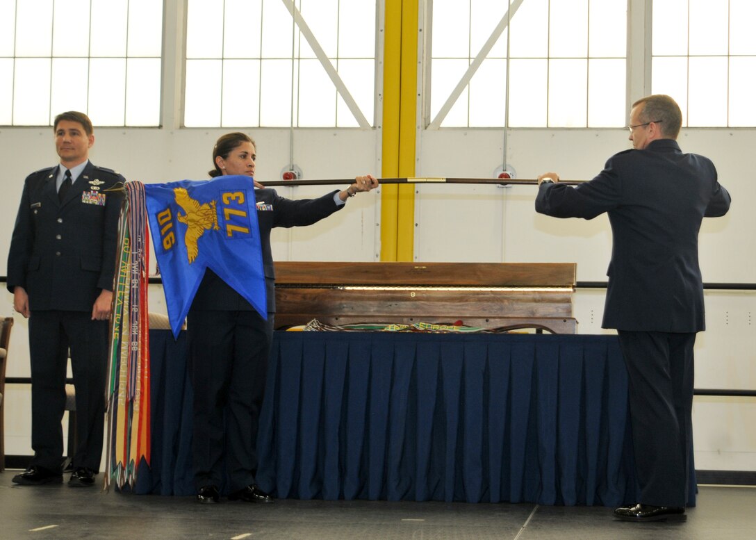 Lt. Col. John Boccieri, commander of the 773rd Airlift Squadron, watches while Master Sgt. Jeannette Holland, 773rd Airlift Squadron First Sergeant, and Lt. Col. Don Loomis, 773rd Airlift Squadron Director of Operations, roll up the squadron guidon during a deactivation ceremony for the 773rd Airlift Squadron here, April 6, 2014. The 773rd Airlift Squadron, which was activated as a unit of the 910th Airlift Wing in 1995, was officially deactivated on March 31. The deactivation resulted from Air Force structure changes that reduced the 910th’s C-130 aircraft fleet to eight Primary Assigned Aircraft and on Back-up Inventory Aircraft. U.S. Air Force photo/Tech. Sgt. Rick Lisum.