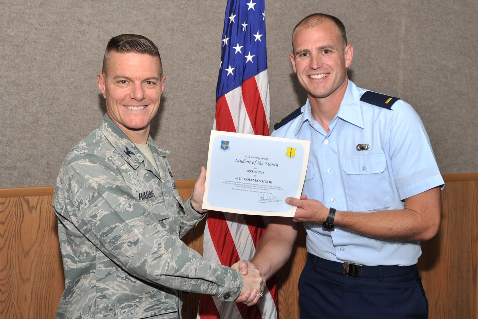 GOODFELLOW AIR FORCE BASE, Texas -- Col. Brendan M. Harris, 17th Training Group Commander, presents the 315th Training Squadron Officer Student of the Month award for March to 2nd Lt. Coleman T. Hook April 4. (U.S. Air Force Photo/ Airman 1st Class Devin Boyer)