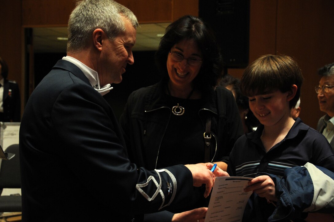 Col. Larry Lang speaks with audience members after a performance by the U.S. Air Force Band at Northwestern University in Evanston, Ill., April 6, 2014. Lang is the commander and conductor of the Band. (U.S. Air Force photo/Master Sgt. Tammie Moore)