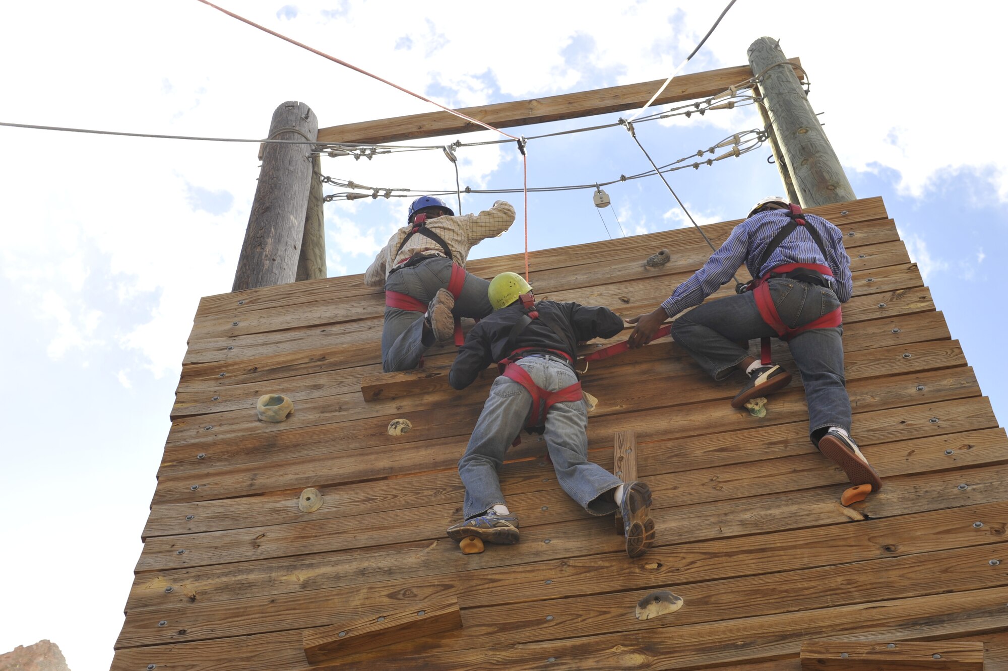 COLORADO SPRINGS, Colo. – Members of Team Pete work together to complete one of two ropes course events during a Rebound retreat sponsored by the Peterson Air Force Base Chapel March 28 at Glen Eyrie. The focus of this event was to get to the top of the wall with a cup of water using communication and support. The retreat focused on communication and conflict resolution. (U.S. Air Force photo/Philip Carter)