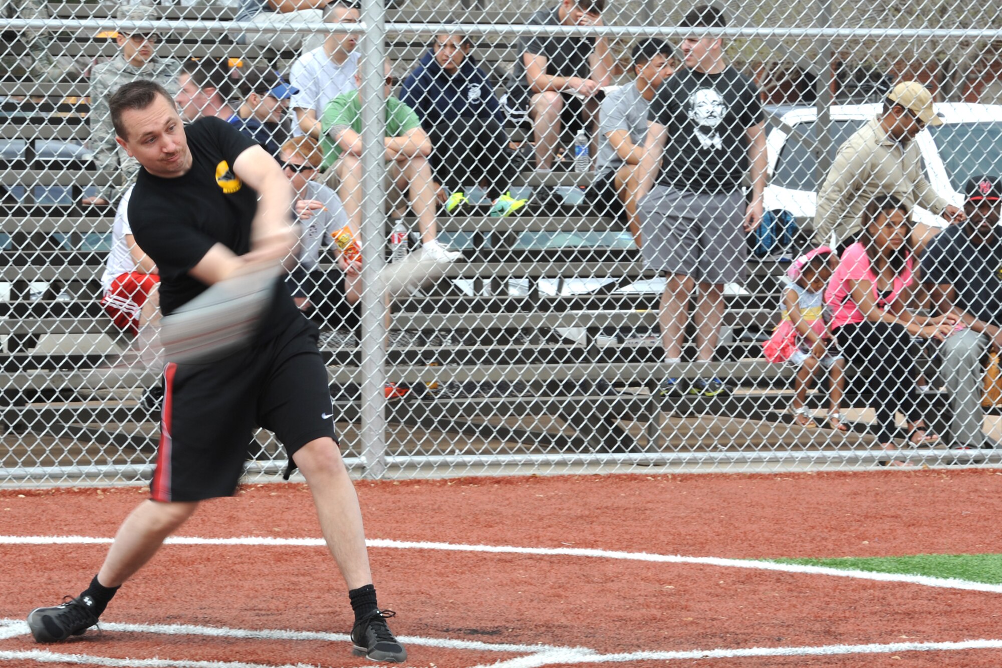 GOODFELLOW AIR FORCE BASE, Texas-- Airman Darrin T. Davis, 17th Contracting Squadron contract administrator and softball team member, throws a pitch during the Mathis Fitness Center multipurpose field grand opening tournament here March 21. The Office of the Secretary of Defense Fitness Program funded the new multipurpose field in 2012 with residual funds from the drawdown of overseas troops, which was used to meet Department of Defense wellness initiatives. (U.S. Air Force photo/ Senior Airman Michael Smith)