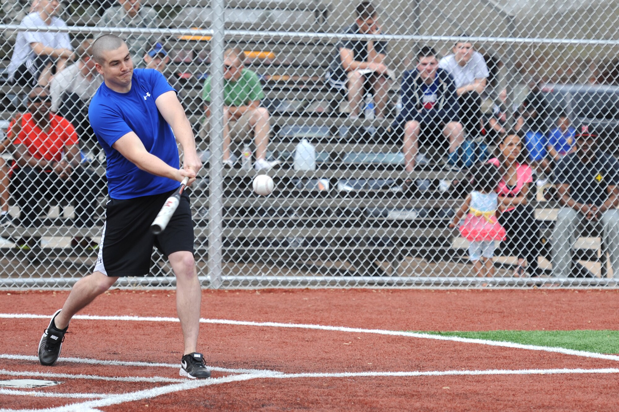 GOODFELLOW AIR FORCE BASE, Texas-- Airman Darrin T. Davis, 17th Contracting Squadron contract administrator and softball team member, throws a pitch during the Mathis Fitness Center multipurpose field grand opening tournament here March 21. The Office of the Secretary of Defense Fitness Program funded the new multipurpose field in 2012 with residual funds from the drawdown of overseas troops, which was used to meet Department of Defense wellness initiatives. (U.S. Air Force photo/ Senior Airman Michael Smith)