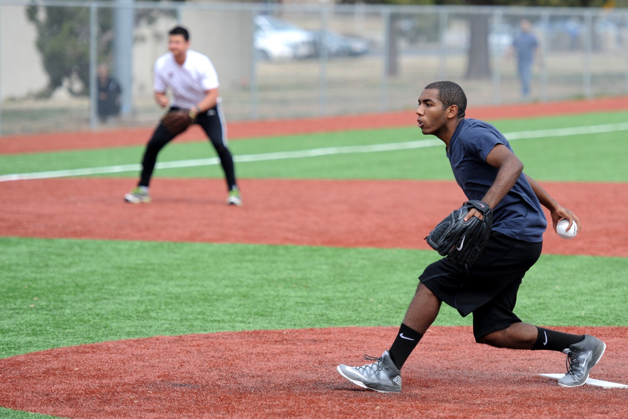 GOODFELLOW AIR FORCE BASE, Texas-- Airman Darrin T. Davis, 17th Contracting Squadron contract administrator and softball team member, throws a pitch during the Mathis Fitness Center multipurpose field grand opening tournament here March 21. The Office of the Secretary of Defense Fitness Program funded the new multipurpose field in 2012 with residual funds from the drawdown of overseas troops, which was used to meet Department of Defense wellness initiatives. (U.S. Air Force photo/ Senior Airman Michael Smith)