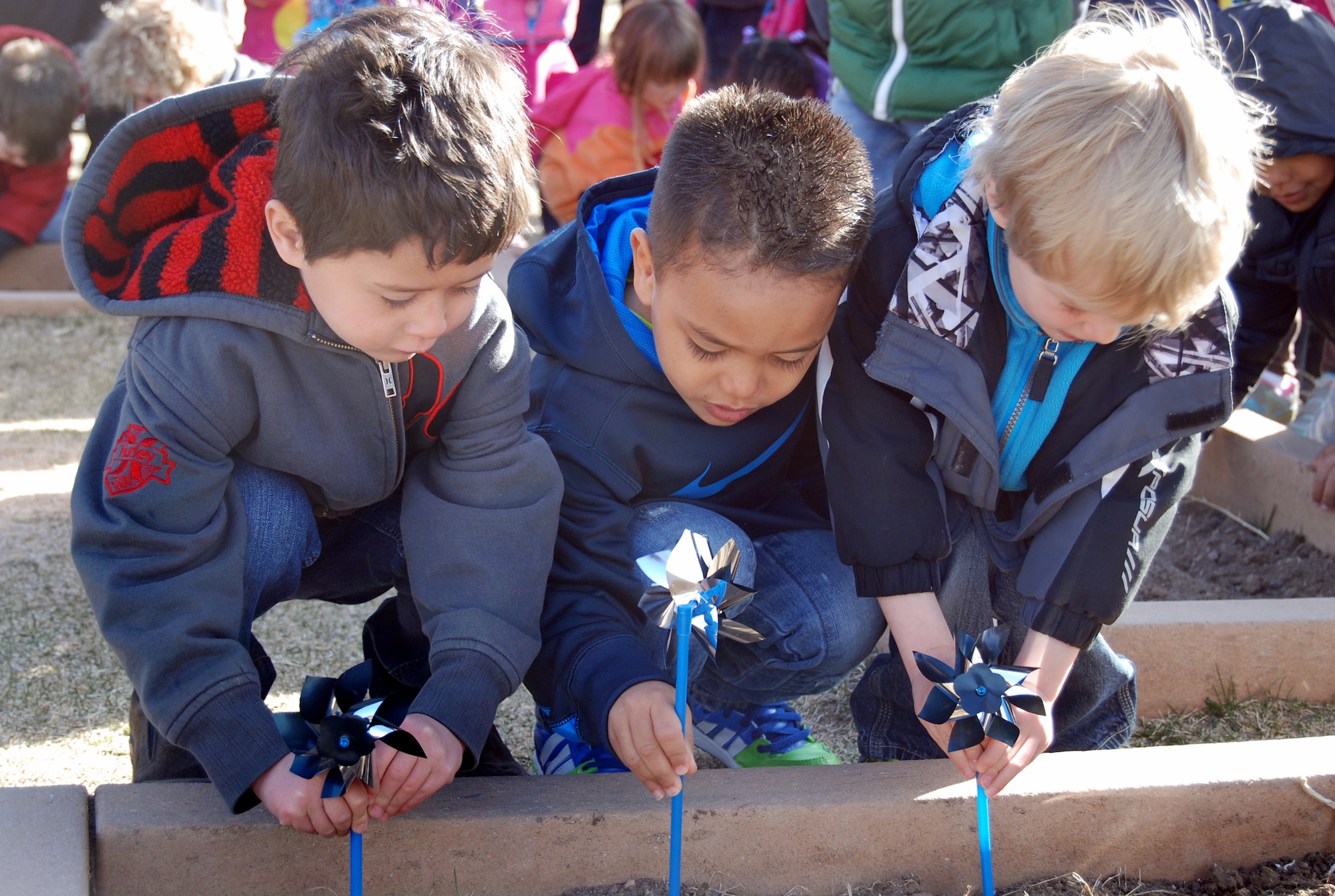 PETERSON AIR FORCE BASE, Colo. – April is Child Abuse Prevention Month and was recognized by the parents, staff and children at the Peterson Child Development Center on April 1. They marked the occasion by giving shiny pinwheels to more than 50 children, which they placed into small flower beds in the CDC playground area. “I call upon all Americans to observe this month with programs and activities that help prevent child abuse and provide for children's physical, emotional, and developmental needs,” President Barack Obama said in his presidential proclamation. Between the main CDC and eastern facility, more than 100 children took part in the event. (U.S. Air Force photo/Michael Golembesky)
