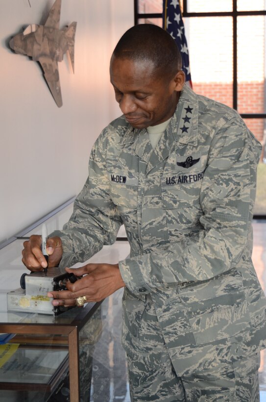 Lt. Gen. Darren McDew, the Commander of the 18th Air Force, signs a radio that had complications when he was flying a KC-135 Stratotanker. McDew was shown the radio while visiting the 126th Air Refueling Wing, Scott Air Force Base, Ill., March 1, 2014. (Air National Guard photo by Senior Airman Elise Stout)