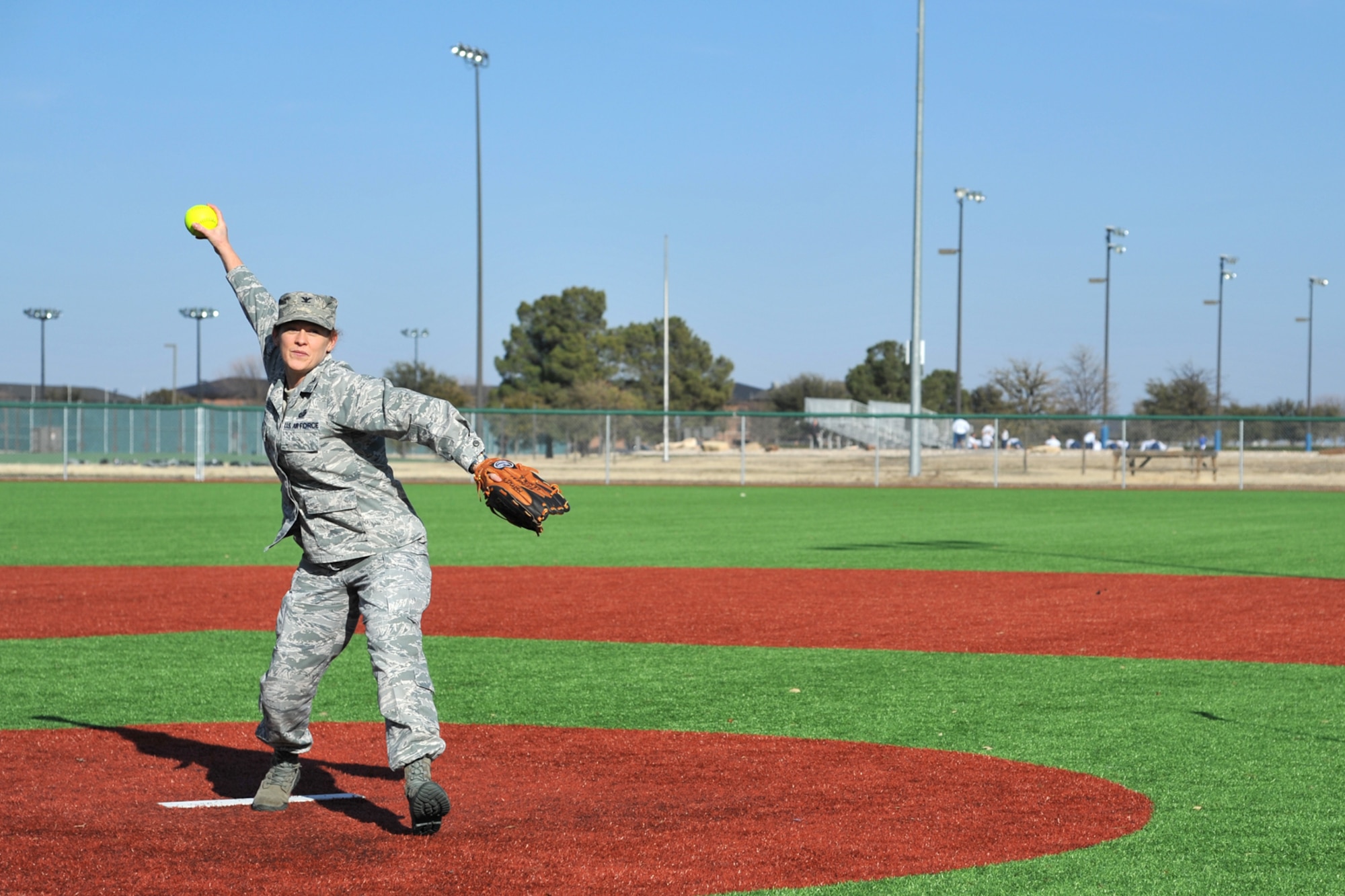 GOODFELLOW AIR FORCE BASE, Texas -- Col. Kimberlee P. Joos, 17th Training Wing Commander, throws the first pitch at the multipurpose field here Feb. 12. The new turf surface alleviates safety concerns associated with holes created by local pests and reduces Goodfellow's water consumption for the field aiding the base in achieving water reduction goals. (U.S. Air Force photo/Senior Airman Michael Smith)