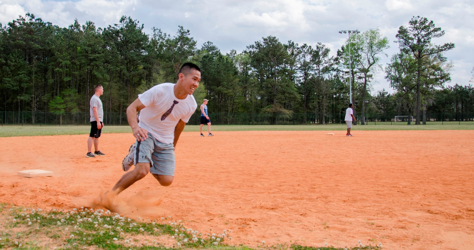 A member of the Strictly Business kickball team rounds third to bring home the winning run April 5, 2014, at Locklear Park on Joint Base Charleston – Weapons Station, S.C. More than 30 teams participated in the kickball tournament which was part of Sexual Assault Awareness Month and provided servicemembers the opportunity to support the Sexual Assault Prevention and Response program. Strictly Business beat 36 other teams to become the third annual kickball tournament champions. (U.S. Navy photo/Petty Officer 3rd Class Jason Pastrick)