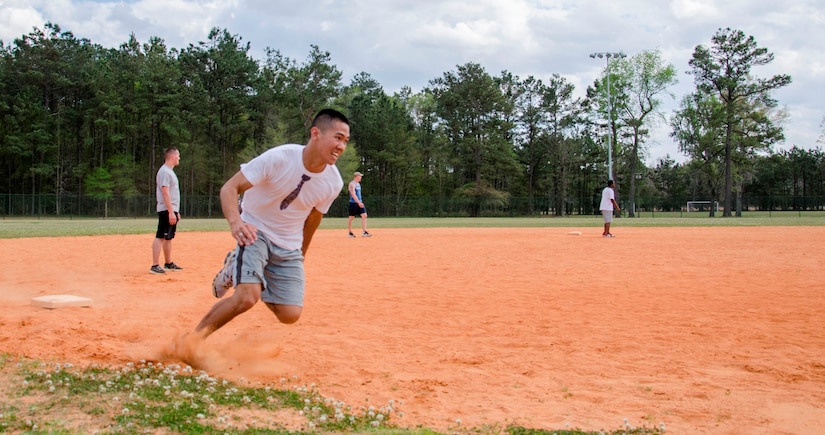 A member of the Strictly Business kickball team rounds third to bring home the winning run April 5, 2014, at Locklear Park on Joint Base Charleston – Weapons Station, S.C. More than 30 teams participated in the kickball tournament which was part of Sexual Assault Awareness Month and provided servicemembers the opportunity to support the Sexual Assault Prevention and Response program. Strictly Business beat 36 other teams to become the third annual kickball tournament champions. (U.S. Navy photo/Petty Officer 3rd Class Jason Pastrick)