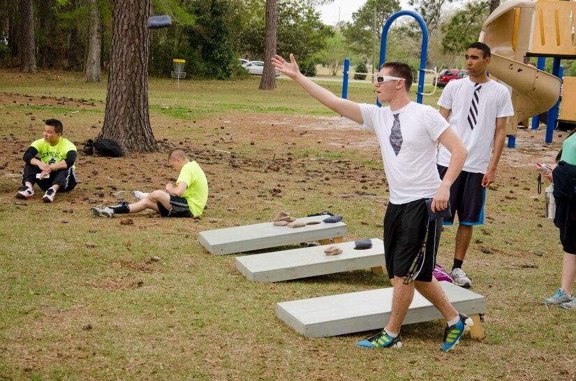 Members of the Strictly Business kickball team, relax between matches by playing a game of Cornhole April 5, 2014, at Locklear Park on Joint Base Charleston – Weapons Station, S.C.  More than 30 teams participated in the kickball tournament which was part of Sexual Assault Awareness Month and provided servicemembers the opportunity to support the Sexual Assault Prevention and Response program. Strictly Business beat 36 other teams to become the third annual kickball tournament champions. (U.S. Navy photo/Petty Officer 3rd Class Jason Pastrick)