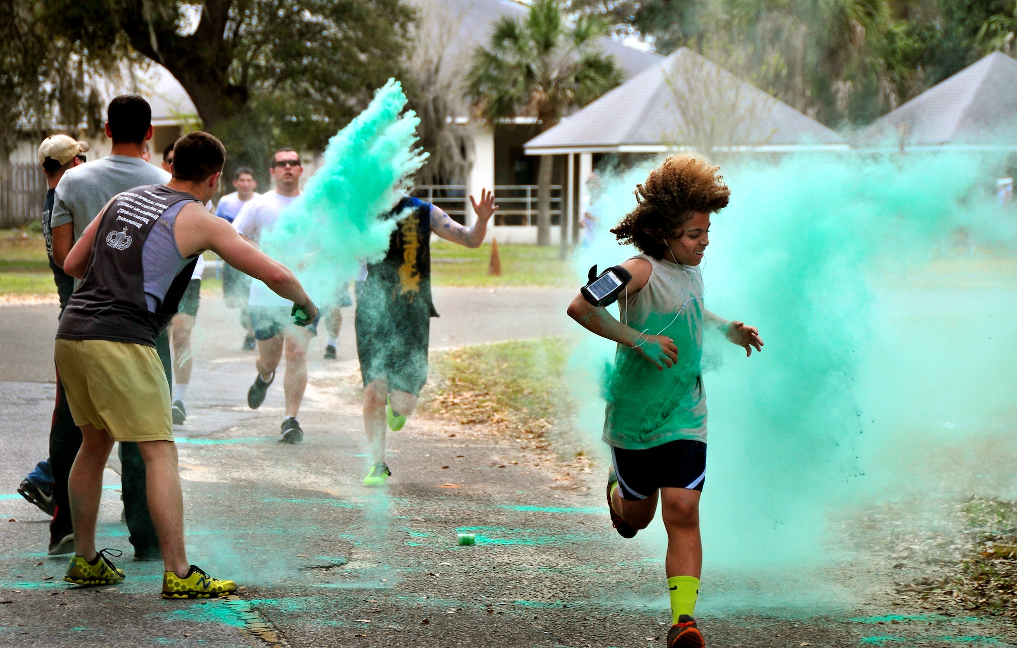 A participant runs through the green dust during the Color Me Aware fun run, April 4, at Eglin Air Force Base, Fla.  Approximately 30 volunteers helped more than 450 participants get colorful during three color zones of the three-mile run.  The event highlighted the start of Sexual Assault Awareness Month. (U.S. Air Force photo/Tech. Sgt. Cheryl Foster)