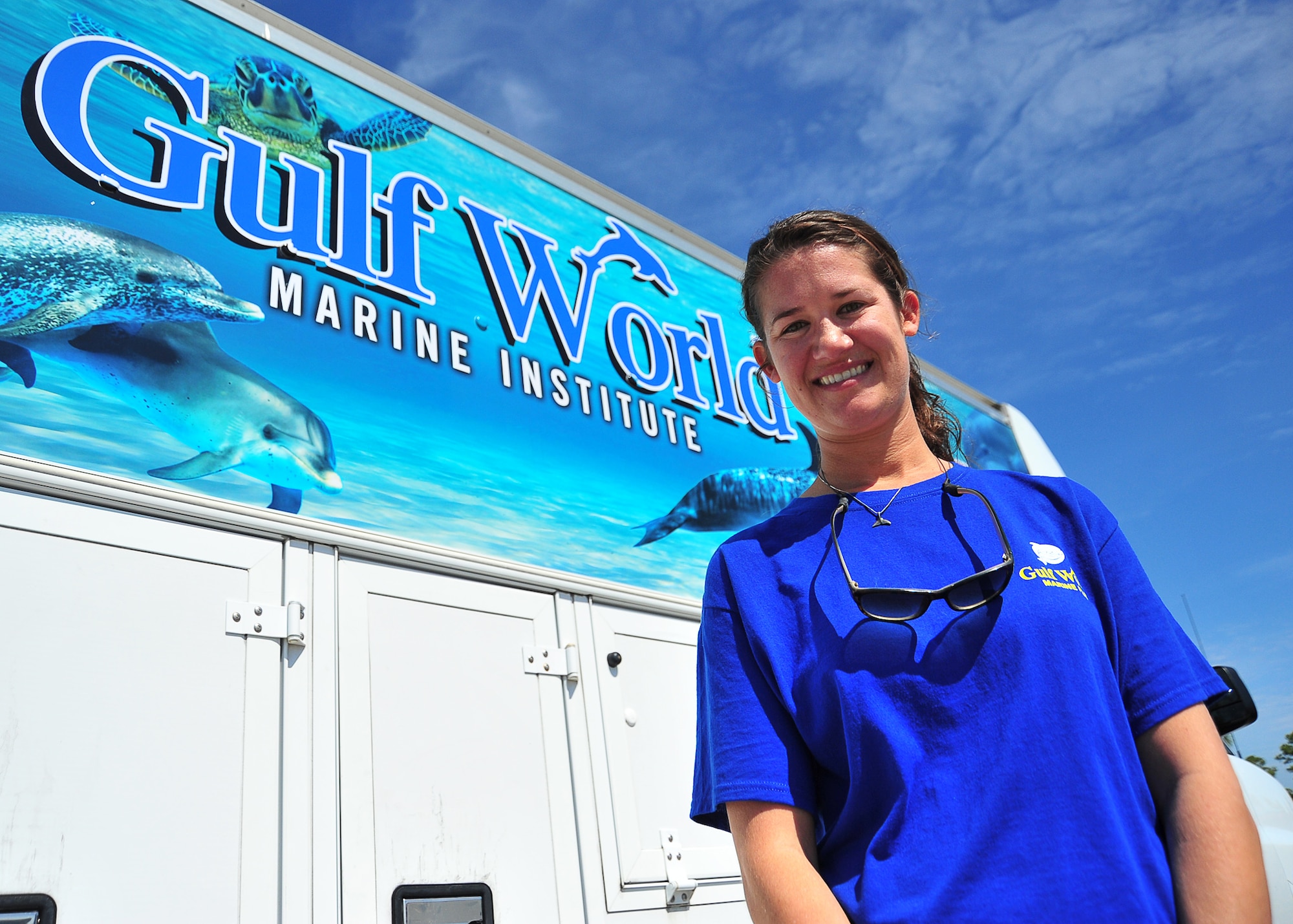 Stephanie Nagel, Gulf World Marine Institute education coordinator, poses for a photo in front of her vehicle April 2 at Crooked Island East Beach. She released two sea turtles after Gulf World Marine Institute rehabilitated them after a cold front in January. (U.S. Air Force photo by Airman 1st Class Sergio A. Gamboa)