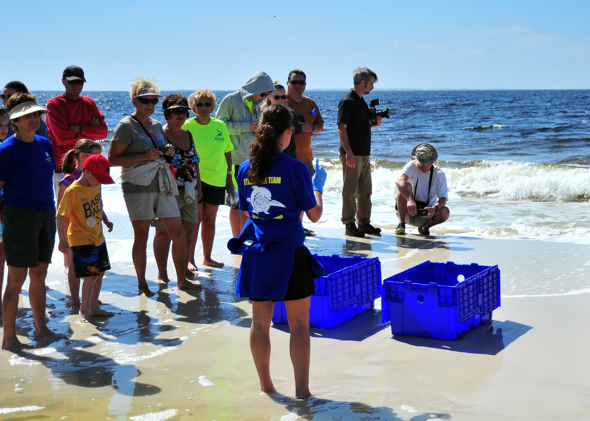 Stephanie Nagel, Gulf World Marine Institute education coordinator, briefs volunteers and spectators about the release of two turtles April 2 at Crooked Island East Beach. The turtles were rehabilitated after a cold front in January. (U.S. Air Force photo by Airman 1st Class Sergio A. Gamboa)