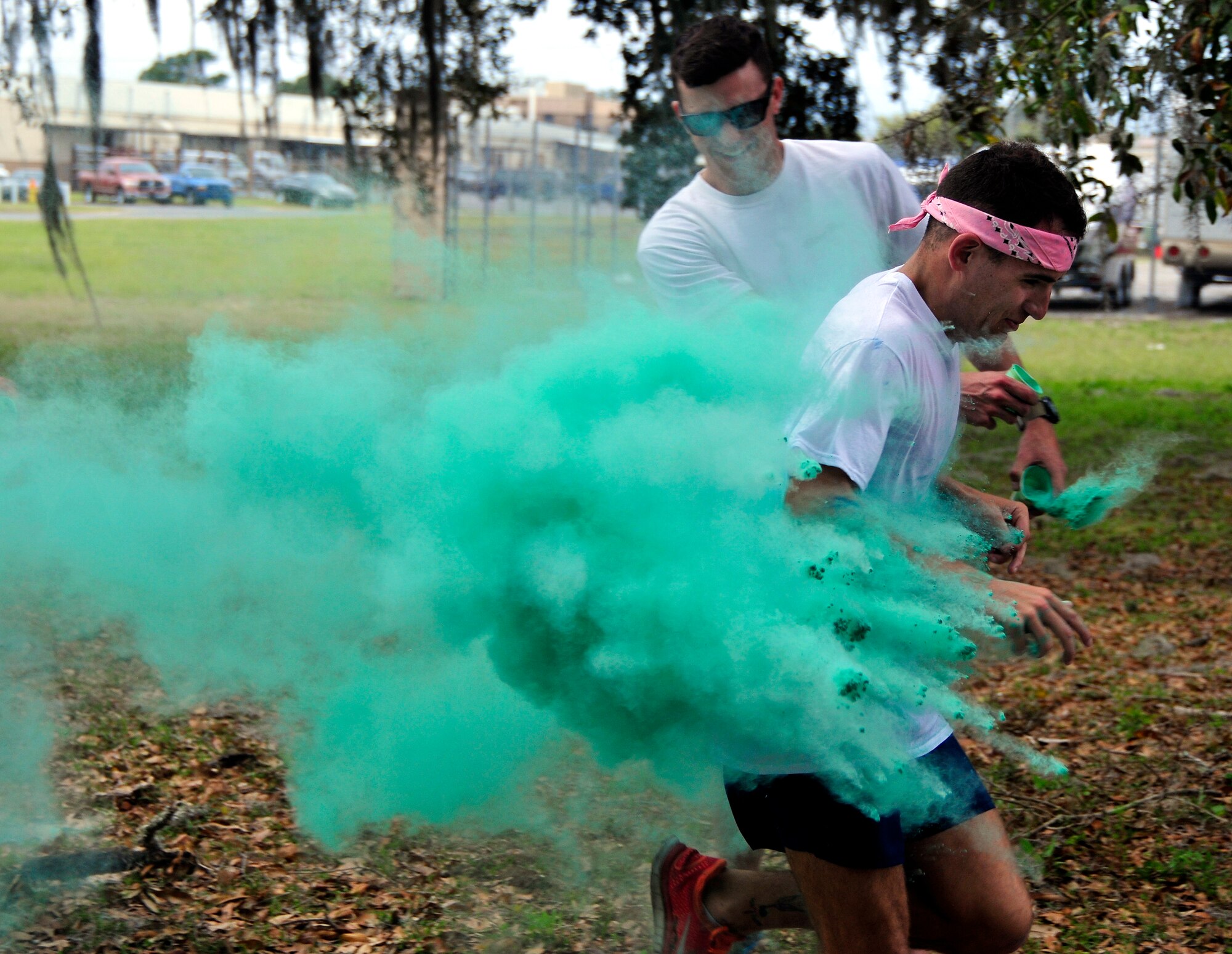 A runner is blasted with green dust during the Color Me Aware fun run, April 4, at Eglin Air Force Base, Fla.  Approximately 30 volunteers helped more than 450 participants get colorful during three color zones of the three-mile run.  The event highlighted the start of Sexual Assault Awareness Month. (U.S. Air Force photo/Tech. Sgt. Cheryl Foster)