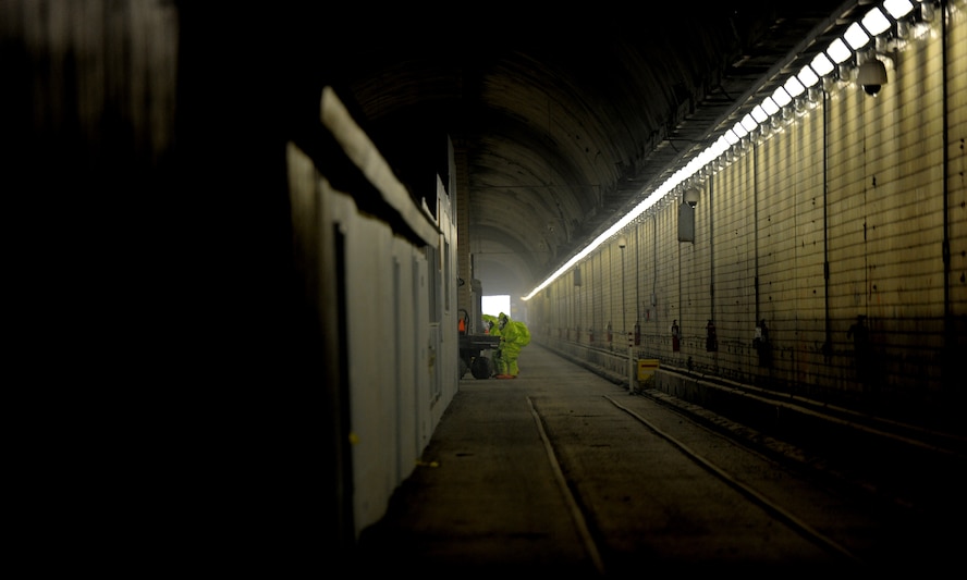 Airmen check their equipment before driving to a hazardous chemical scenario site at the Center for National Response in W.Va., March 27, 2014. The approximately half-mile long Memorial Tunnel is one of many venues the CNR offers for consequence and crisis management emergency response exercises. The tunnel itself also offers replicas of a post office, rail station, chemical labs, an Afghanistan tunnel, rubble room and a metro rail car. (U.S. Air Force Photo/ Airman 1st Class Nesha Humes)