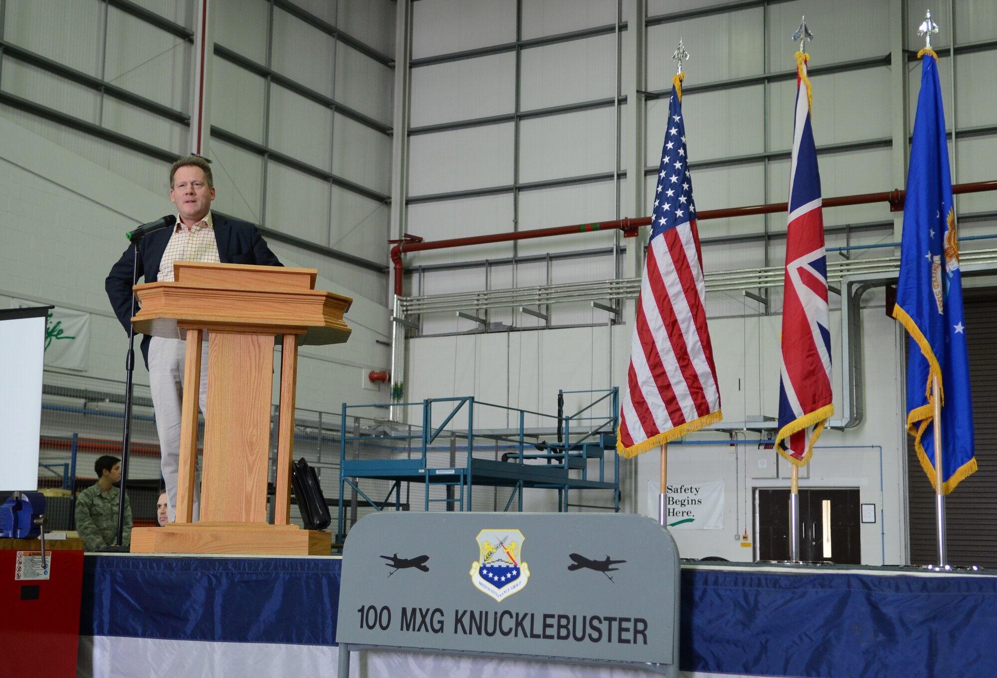 Adam Holloway, Member of Parliament, speaks to attendees at the 2014 100th Maintenance Group and 100th Logistics Readiness Squadron Knucklebuster Awards April 3, 2014, on RAF Mildenhall, England. Holloway, a former British army member, shared stories of deployed operations and experiences working with the Air Force. (U.S. Air Force photo by Airman 1st Class Dillon Johnston/Released)