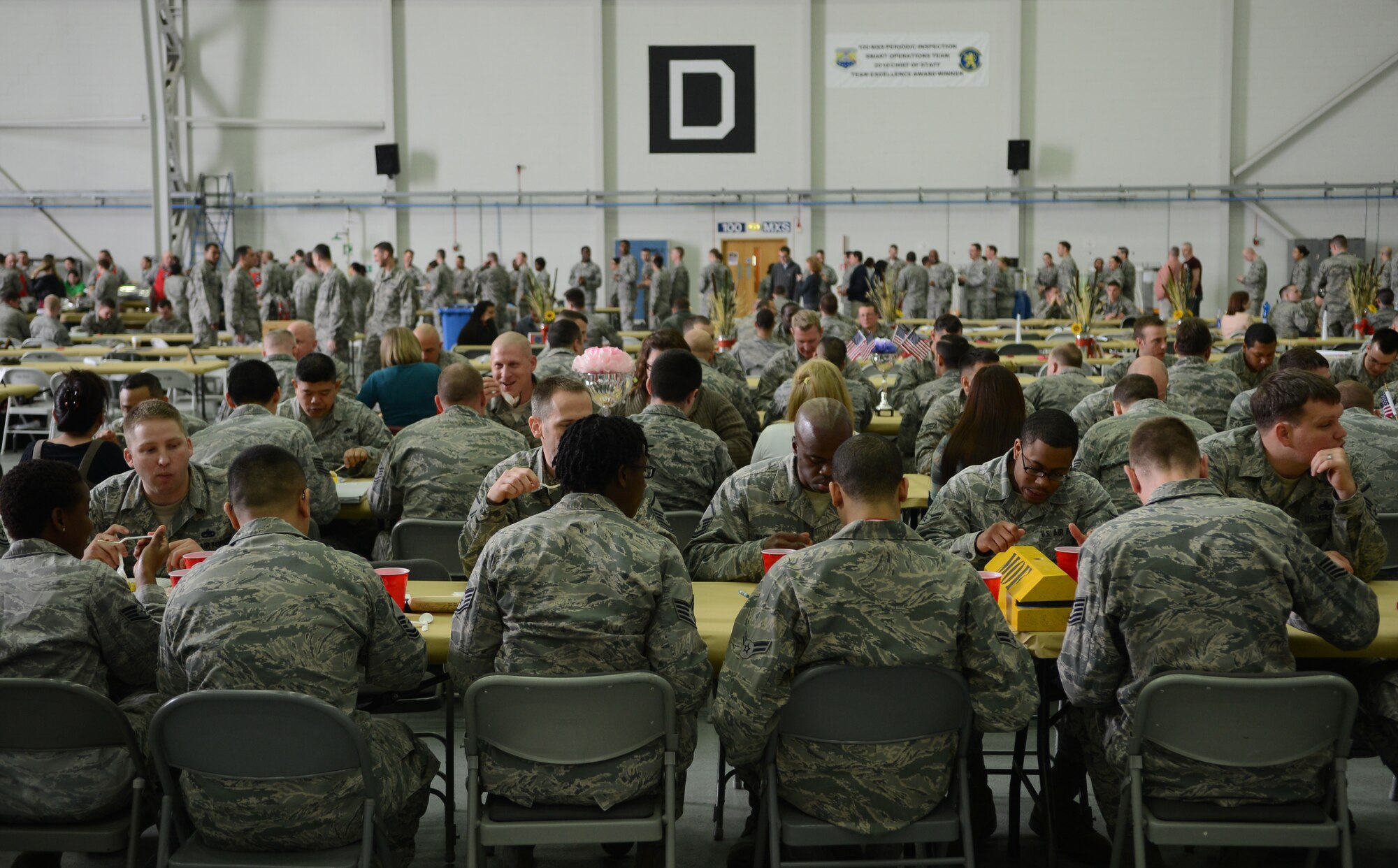 Team Mildenhall members eat lunch April 3, 2014, during the 2014 100th Maintenance Group and 100th Logistics Readiness Squadron Knucklebuster Awards on RAF Mildenhall, England. Attendees ate a buffet-style lunch served by base leaders before the leaders handed out awards to Airmen for various skills displayed. (U.S. Air Force photo by Airman 1st Class Dillon Johnston/Released)
