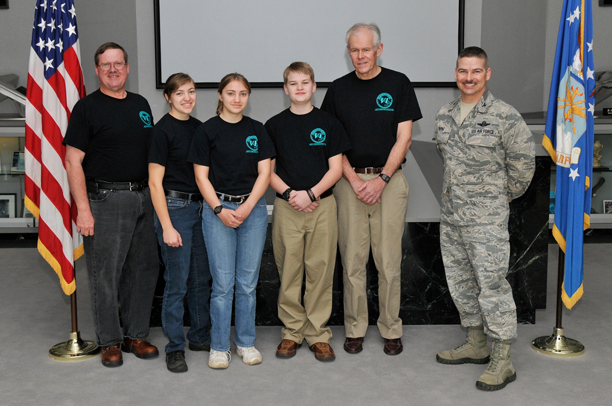 Arnold Engineering Development Complex (AEDC) Commander Col. Raymond Toth congratulates the Civil Air Patrol Tullahoma Composite Squadron CyberPatriot Team for their third place award. Pictured left to right is AEDC Mentor Michael Glennon, Senior Member Esther Mahoney, Cadet Master Sgt. Elizabeth Mahoney, Cadet Airman Jacob Van Horn, CyberPatriot Team Coach James Mainzer and Toth.
