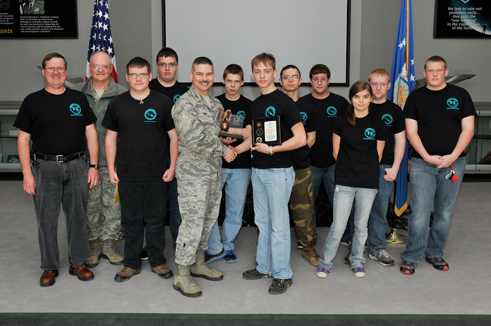 Arnold Engineering Development Complex (AEDC) Commander Col. Raymond Toth congratulates the Coffee County Central High School Air Force Junior ROTC CyberPatriot Team for the first place award. Pictured left to right is AEDC Mentor Michael Glennon, CyberPatriot Team Coach Lt. Col. Philip Bailey, Cadet Tech Sgt. Clayton Whitt, Cadet Senior Master Sgt. Dawson Carlton, Toth, Cadet Airman Buster Haney, Cadet Senior Airman Alex Duncan, Cadet Staff Sgt. Kayla Perry, Cadet 2nd Lt. Steven Messick and Cadet Capt. Jacob Norton.