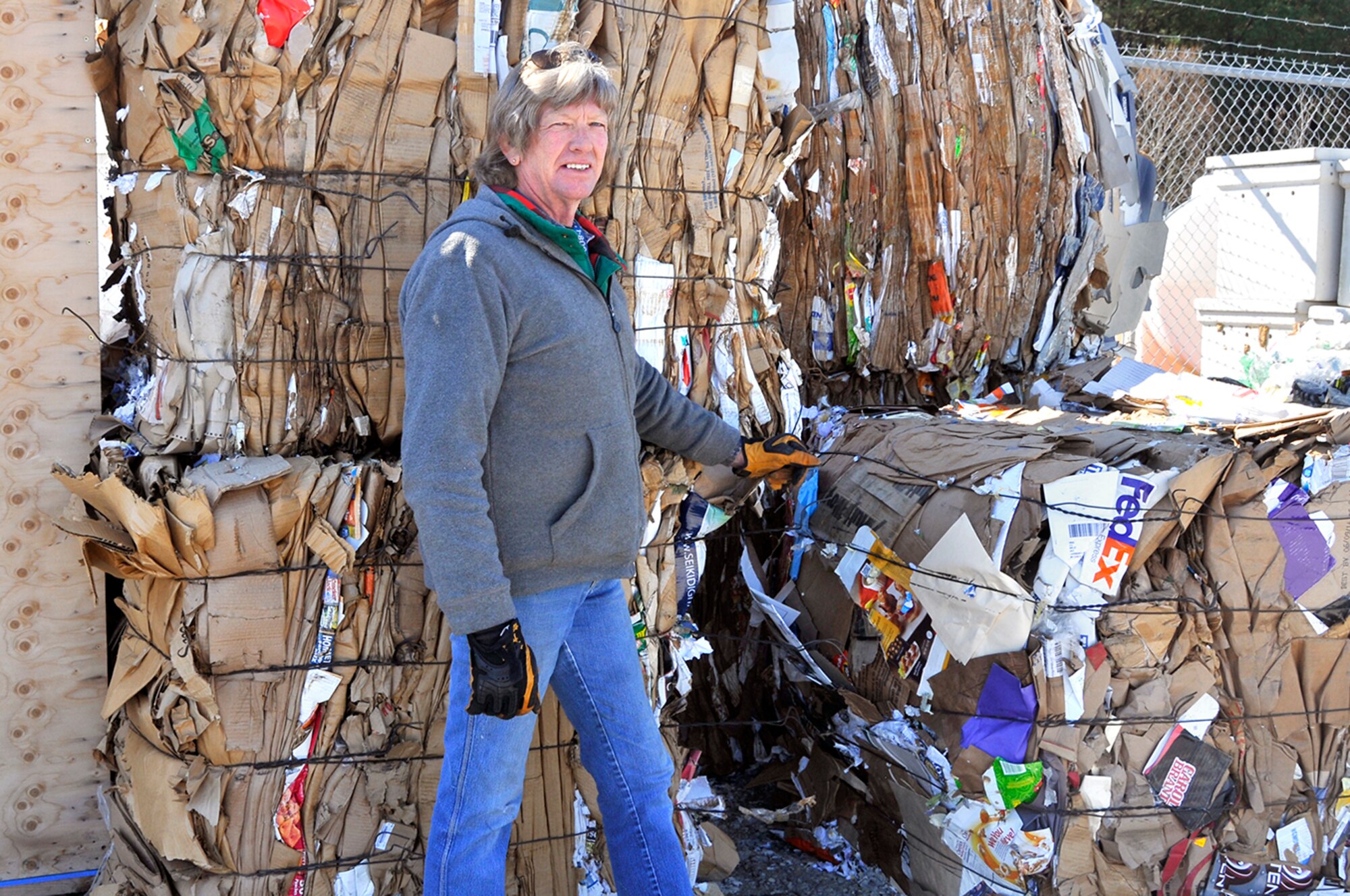 Green Team member Doug Richards, pictured here, explains that the Arnold Engineering Development Complex Services Recycling Program processes roughly 280 tons of cardboard shown here in bales ready for transport for recycling each year. (Photo by Jacqueline Cowan)