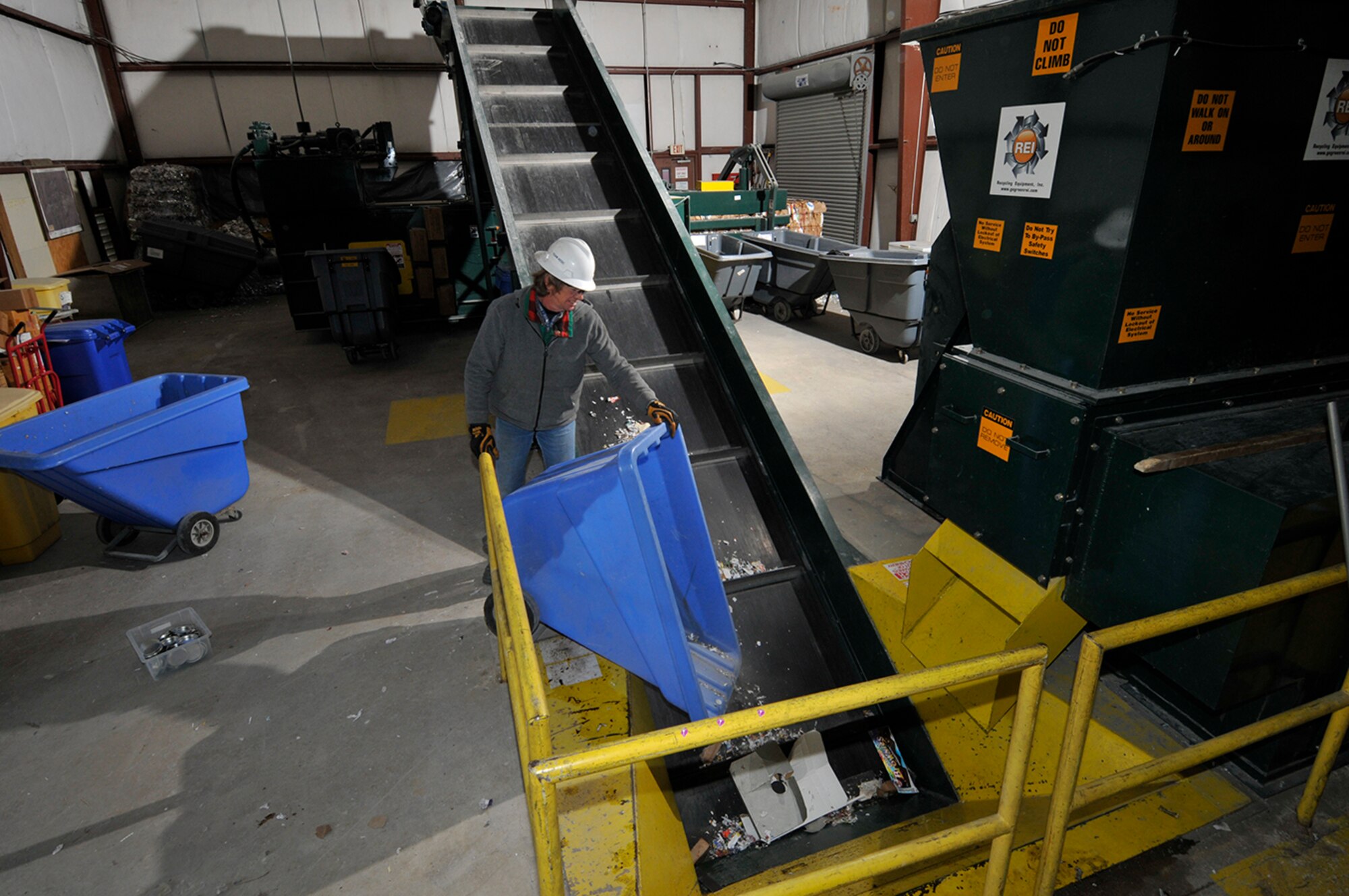 The Arnold Engineering Development Complex Services Recycling Center uses various equipment such as this multipurpose baler, demonstrated by Green Team member Doug Richards, to compact and bale cardboard and other materials for recycling. (Photo by Rick Goodfriend)