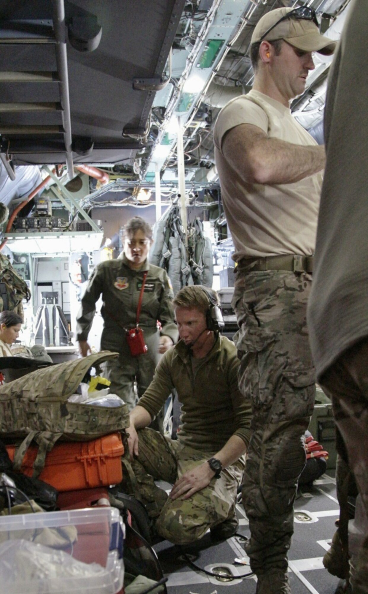 Crew from the 129th Rescue Wing in California conduct a briefing April 3, 2014, before four pararescuemen jump into the Pacific Ocean to rescue a family stranded at sea with a critically ill infant. (Photo by Airman 1st Class Julia Bates)
