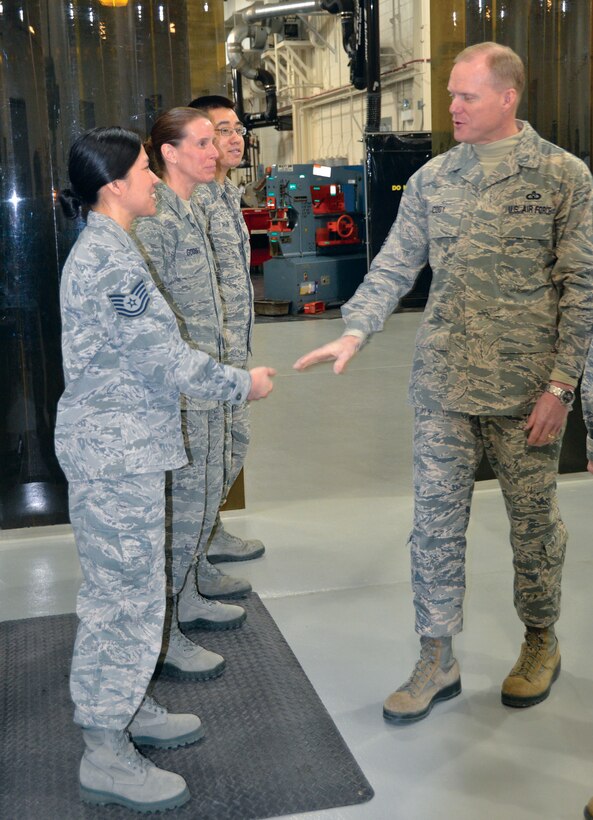WRIGHT-PATTERSON AIR FORCE BASE, Ohio - Chief Master Sgt. of the Air Force James A. Cody presents coins to Tech. Sgt. Herodina Lu, 445th Aerospace Medicine Squadron, Staff Sgt. Jennifer Godsey, 445th Force Support Squadron services sustainment flight, and Senior Airman Thao T. Phan, 445th Maintenance Squadron, for their outstanding contributions to the 445th Airlift Wing during his visit to Wright-Patterson Air Force Base March 21. (U.S. Air Force photo/Stacy Vaughn)