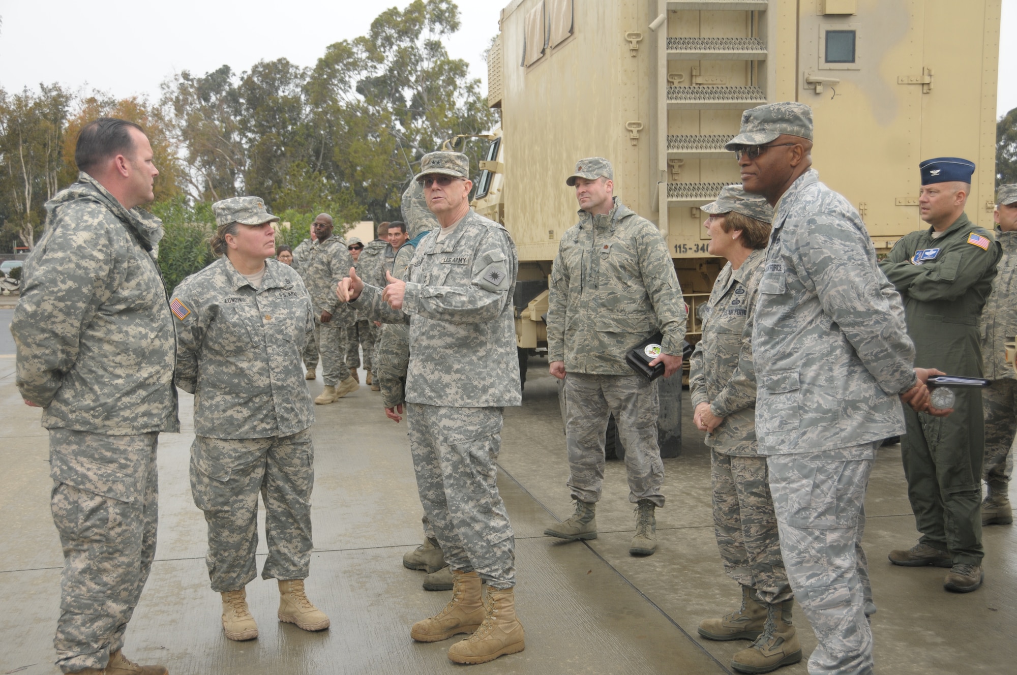 Major General Keith D. Jones, commander of the 40th Infantry Division in Los Alamitos, Calif. is briefed by Soliders from the 340th Bravo Company and Airmen from the 14th Airlift Wing during a during a Joint Reception Staging Onward Integration exercise training on March 1, 2014. Maj. Gen. Jones was on-hand to observe the exercise and progress of Soliders and Airmen during this JRSOI prep.  (Air National Guard photo by Airman First Class Madeleine Richards)
