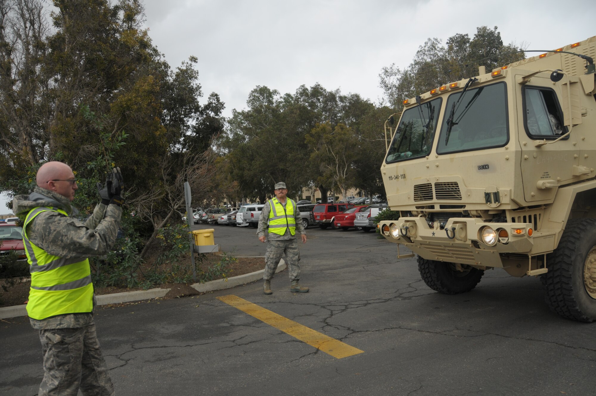 Military vehicles carrying Soldiers from the 340th Bravo Company drive through the main gate at the 146th Airlift Wing to meet with U.S. Air National Guard members in Port Hueneme, Caif., during a Joint Reception Staging Onward Integration exercise training on March 1, 2014. (Air National Guard photo by Airman First Class Madeleine Richards)